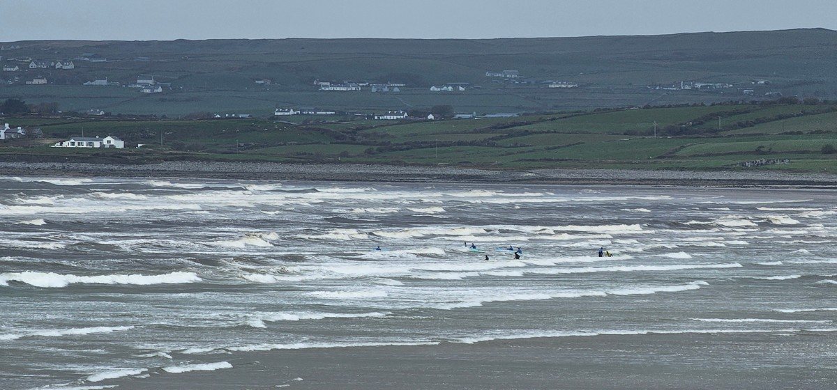 group of beginner surfers in the water at the north end of the beach